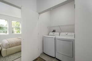 Washroom with washer and clothes dryer