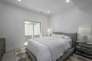 Bedroom with recessed lighting, access to exterior, and baseboards