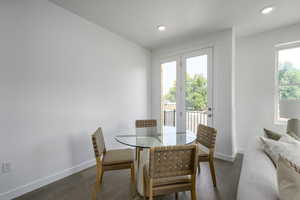 Dining room with baseboards, wood finished floors, and recessed lighting