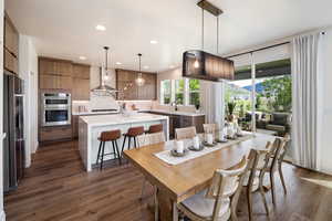 Dining space featuring dark wood finished floors and recessed lighting