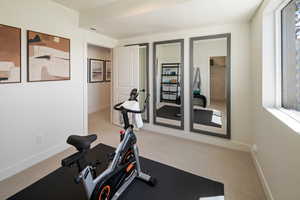 Exercise room featuring carpet and baseboards