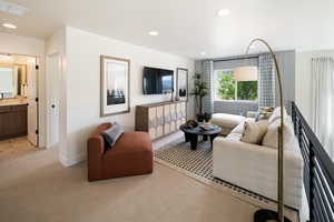 Living room with light carpet, recessed lighting, and baseboards