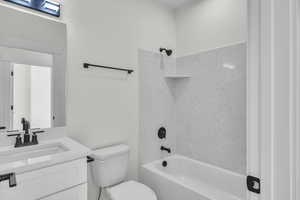 Full bath with shower / washtub combination, toilet, and vanity