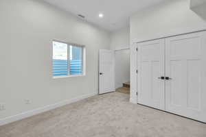 4th bedroom below grade area featuring light carpet, baseboards, and recessed lighting. Could be used for an office or game room.