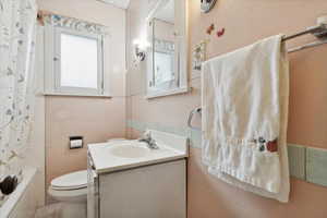 Full bath with toilet and vanity
