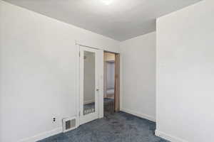 Empty room featuring carpet flooring and baseboards