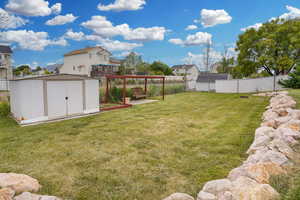 View of yard with a storage unit and an outdoor structure