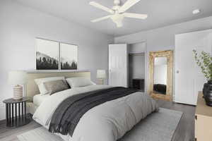 Master bedroom featuring LVP wood look floors, a textured ceiling, baseboards, and a ceiling fan