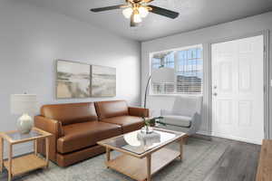 Living room with a ceiling fan, LVP, wood look finished floors, baseboards, and a textured ceiling