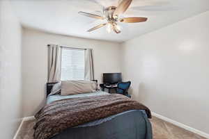 Carpeted bedroom with view of the back yard.
