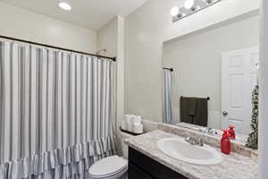 Full bathroom featuring vanity and toilet