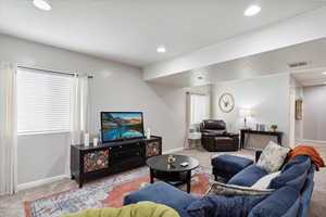Huge family room with carpet featuring windows with great natural lighting, and recessed lighting