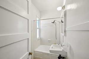 Full bath featuring a sink and  shower combination