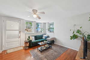 Living room with wood finished floors and a ceiling fan