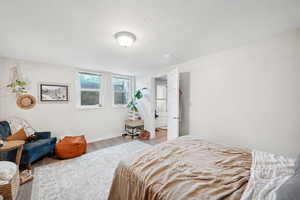Bedroom with wood finished floors and baseboards