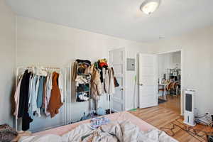 Bedroom featuring wood finished floors and electric panel