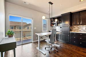 Office featuring dark wood-style floors and baseboards