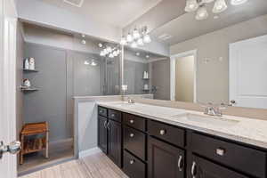 Bathroom featuring double vanity and a walk in shower
