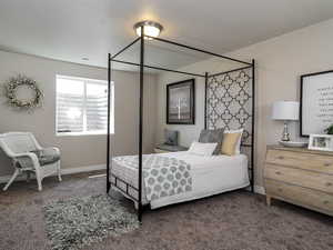 Bedroom featuring carpet and baseboards