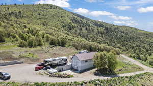 View from above of property with a forest and a mountain backdrop