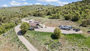 View of subject property featuring a mountain backdrop and a forest