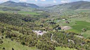 View of property location with mountains and a forest