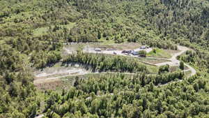 Aerial view of property's location featuring a forest