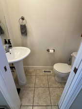 Bathroom with baseboards and light tile patterned flooring