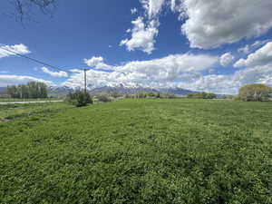 View of green lawn featuring a view of countryside and a mountain view