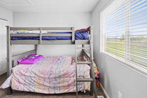 Bedroom featuring carpet flooring, multiple windows, and baseboards