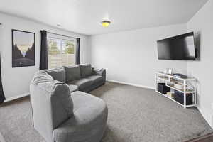 Living area with carpet and baseboards