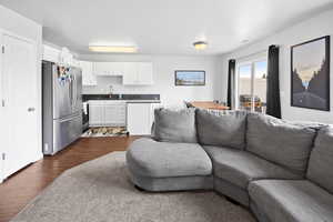 Living room featuring dark wood-style flooring