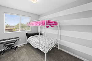 Carpeted bedroom featuring baseboards