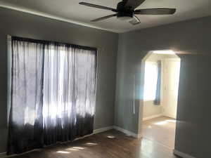 Unit B living room  featuring a ceiling fan, baseboards, and wood finished floors
