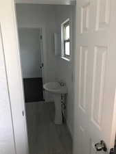 Unit A Bathroom with tile patterned floors, baseboards, and a sink