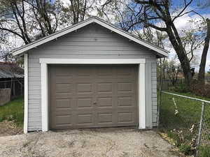 Detached garage featuring fence