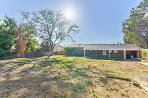 View of yard with fence and a patio area