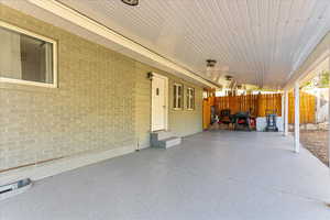 View of patio featuring fence