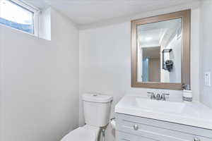 Half bathroom featuring toilet and vanity