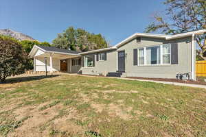 Ranch-style house featuring a carport, a mountain view, brick siding, and entry steps