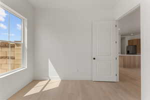 Empty room with light wood finished floors and baseboards