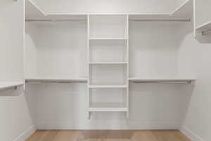 Spacious closet featuring wood finished floors