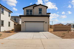 View of front of property with a tile roof, stucco siding, a garage, driveway, and fence