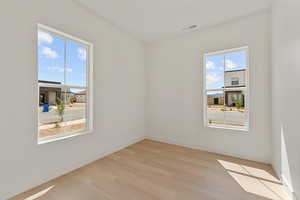 Unfurnished room featuring light wood-style floors and baseboards