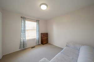 Carpeted bedroom with baseboards