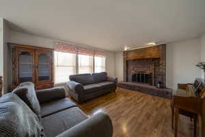 Living room with a fireplace and wood finished floors