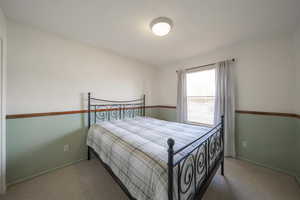 Carpeted bedroom with baseboards
