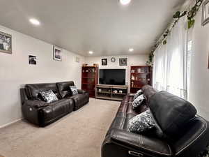 Living room featuring carpet flooring, recessed lighting, and baseboards