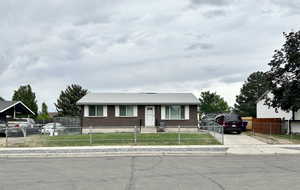 View of front of property with brick siding and concrete driveway