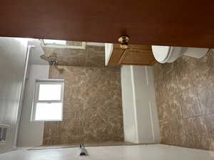 Full bathroom with toilet, vanity, and shower / tub combo